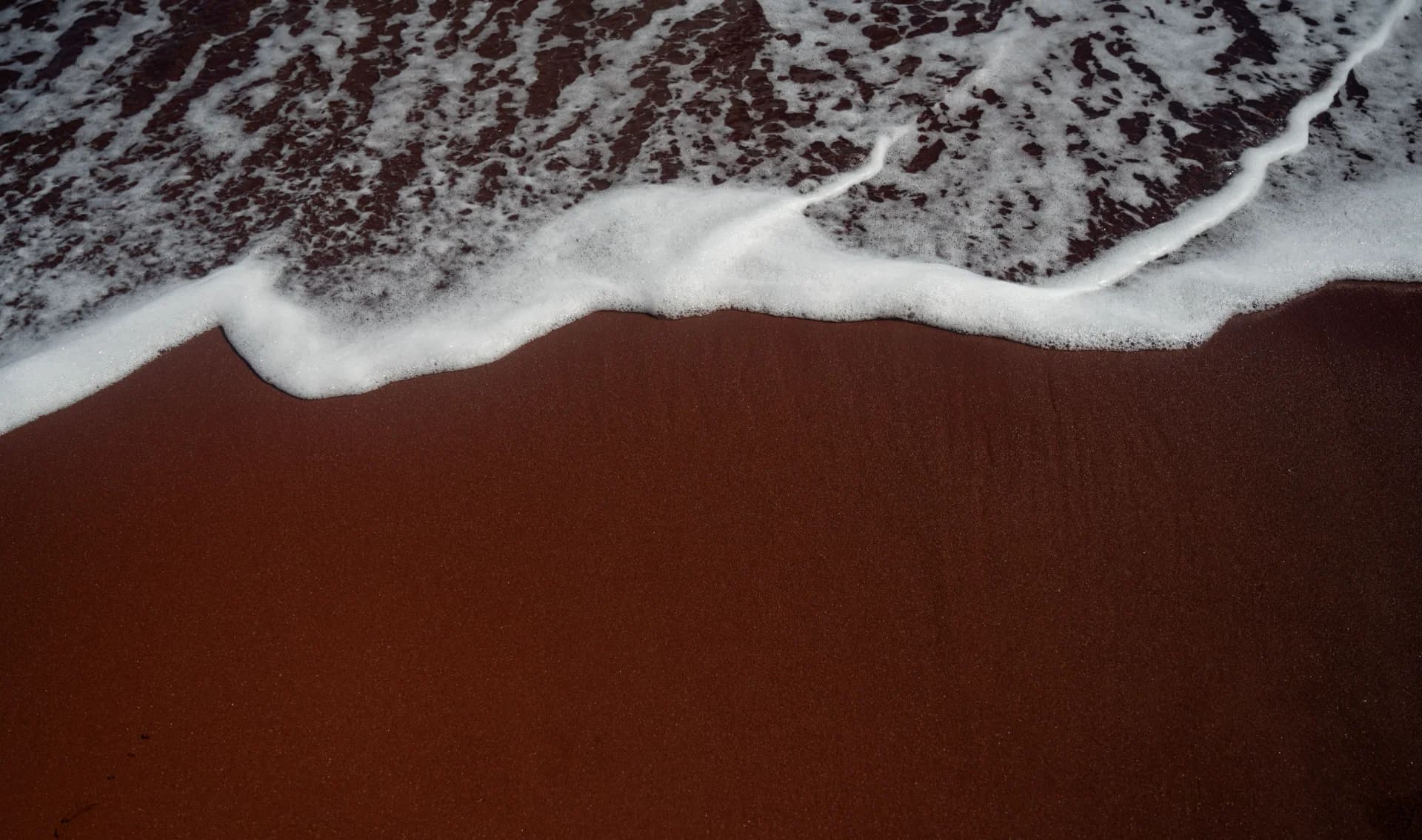 Waves on a red beach