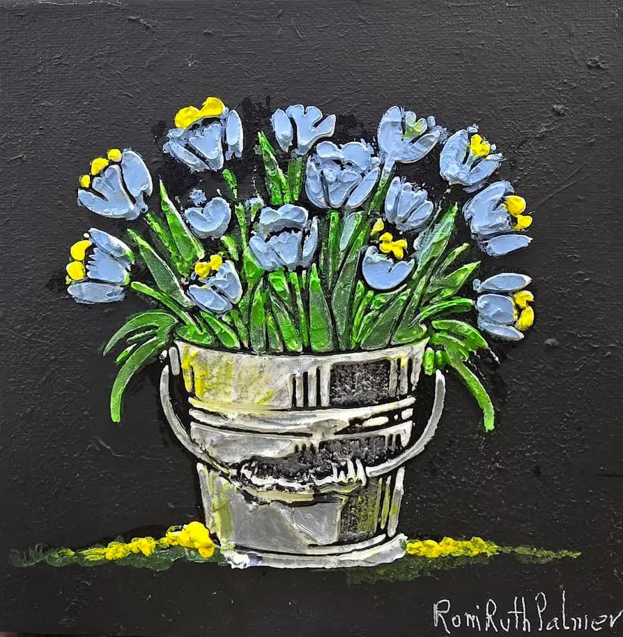 A pair of small paintings. A bucket with blue and pink flowers.