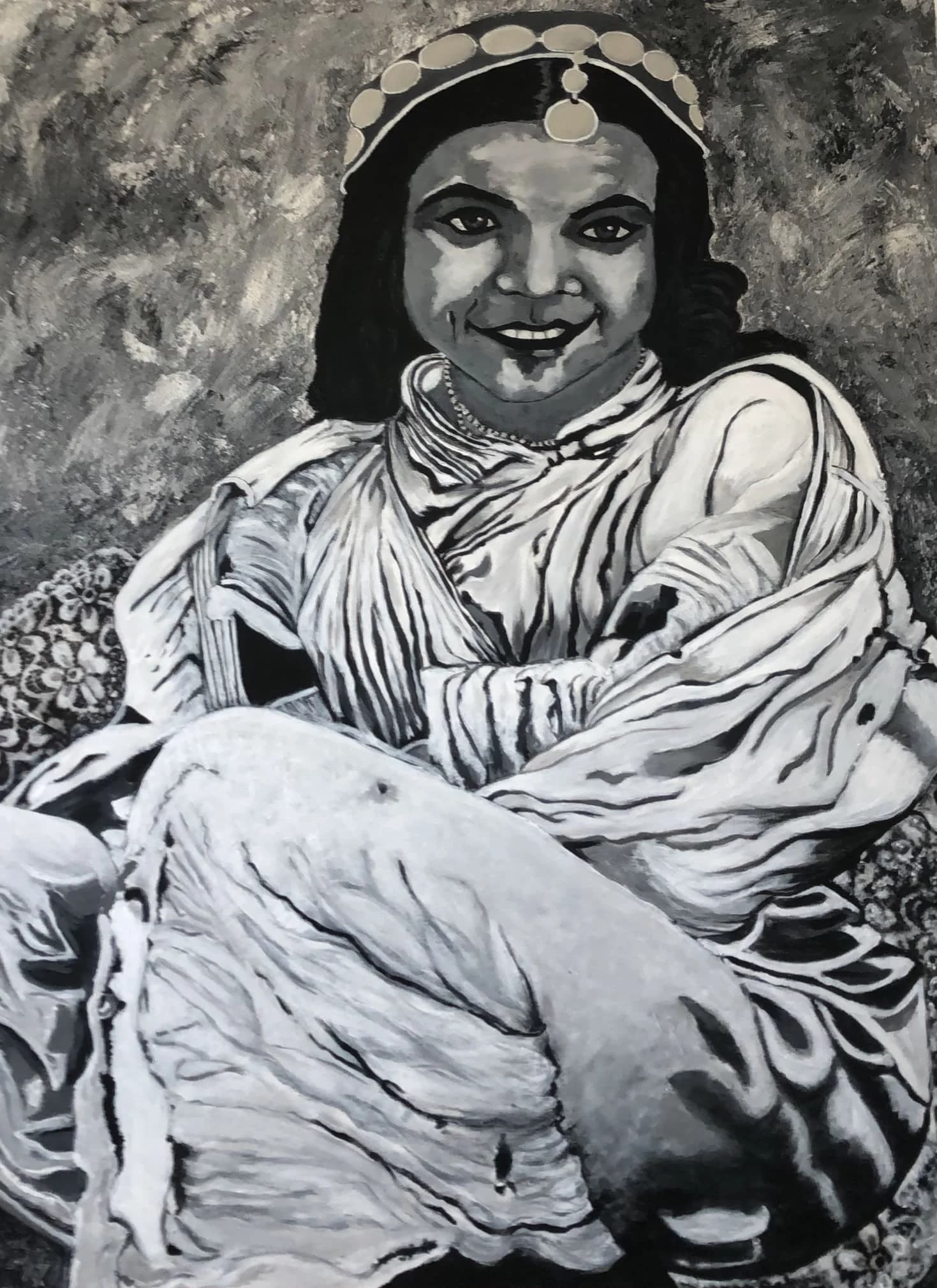 A Moroccan woman from the 1936s is sitting on the ground